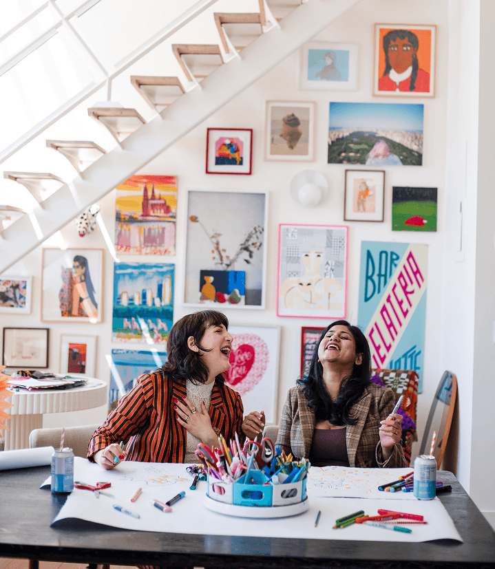Piera and Lakshmi at table with art supplies